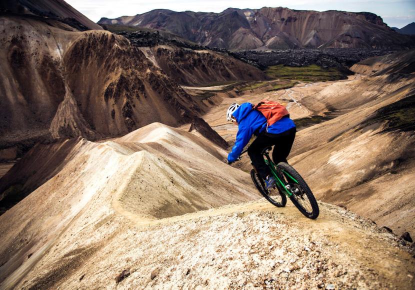 Mountain Biker riding across hill ridges in Iceland