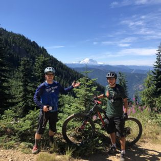 mountain bikers enjoying the view of mt rainier in washington state from kachess ridge
