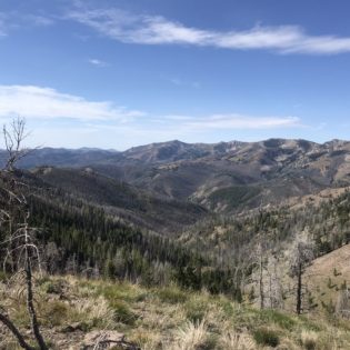 Looking out over rocky valley under blue sky