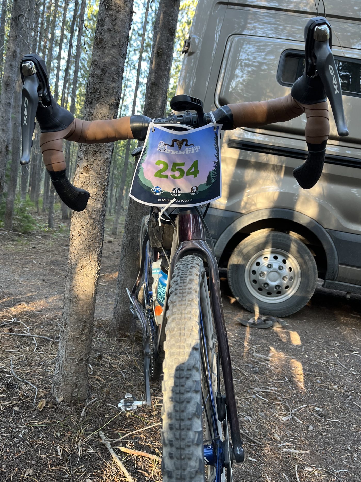 Front view of gravel bike with paper race card, number 254, attached to handle bars.